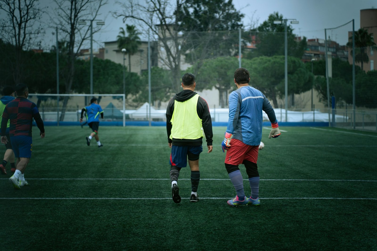 Adult footballers preparing together on the pitch